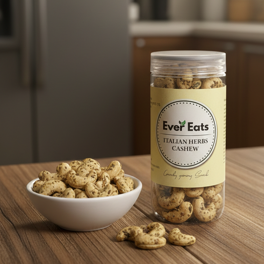Jar of Ever Eats Italian Herbs Cashew on a kitchen counter with a bowl of cashews.
