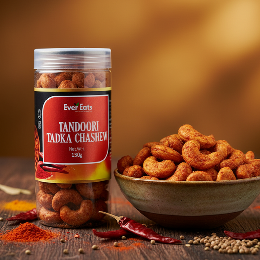 Jar of Tandoori Tadka Chashew with a bowl of cashews on a wooden surface.